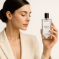 sexy girl holding and looks like admiring bottle of Agonist White Lies fragrance